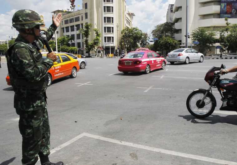יותר מ-20 הפיכות צבאיות - חייל בצבא תאילנד מכוון את התנועה אחרי הפיכה. רויטרס