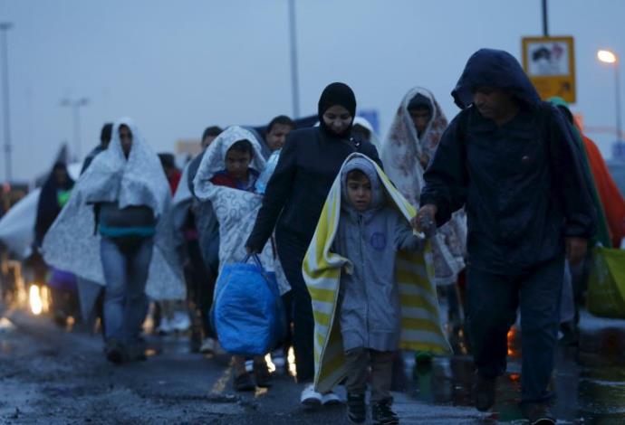 מהגרים מגיעים לגבול בין הונגריה לאוסטריה (צילום:  רויטרס)