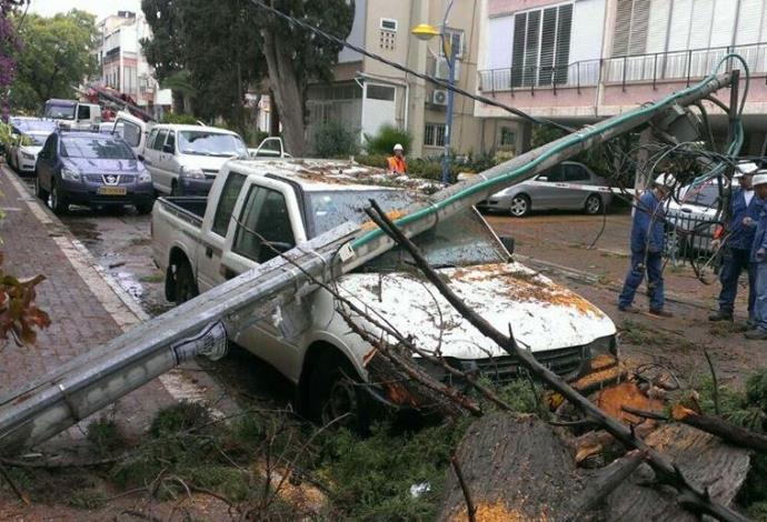 עמוד חשמל שקרס על רכב בגלל פגעי הסערה (צילום:  פייסבוק חברת החשמל)