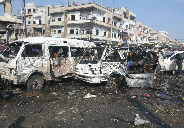 אוטובוסים חרוכים עקב סדרת פיגועים בעיר חומס בסוריה. צילום: רויטרס