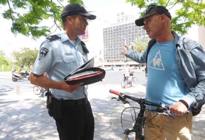 רוכב אופניים מקבל קנס בתל אביב (צילום:  אבשלום ששוני)
