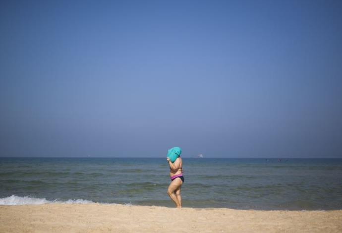 אישה בחוף הים באשדוד (צילום:  פלאש 90)