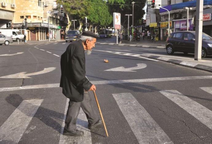 קשיש חוצה את הכביש (צילום:  סרג' אטאל, פלאש 90)